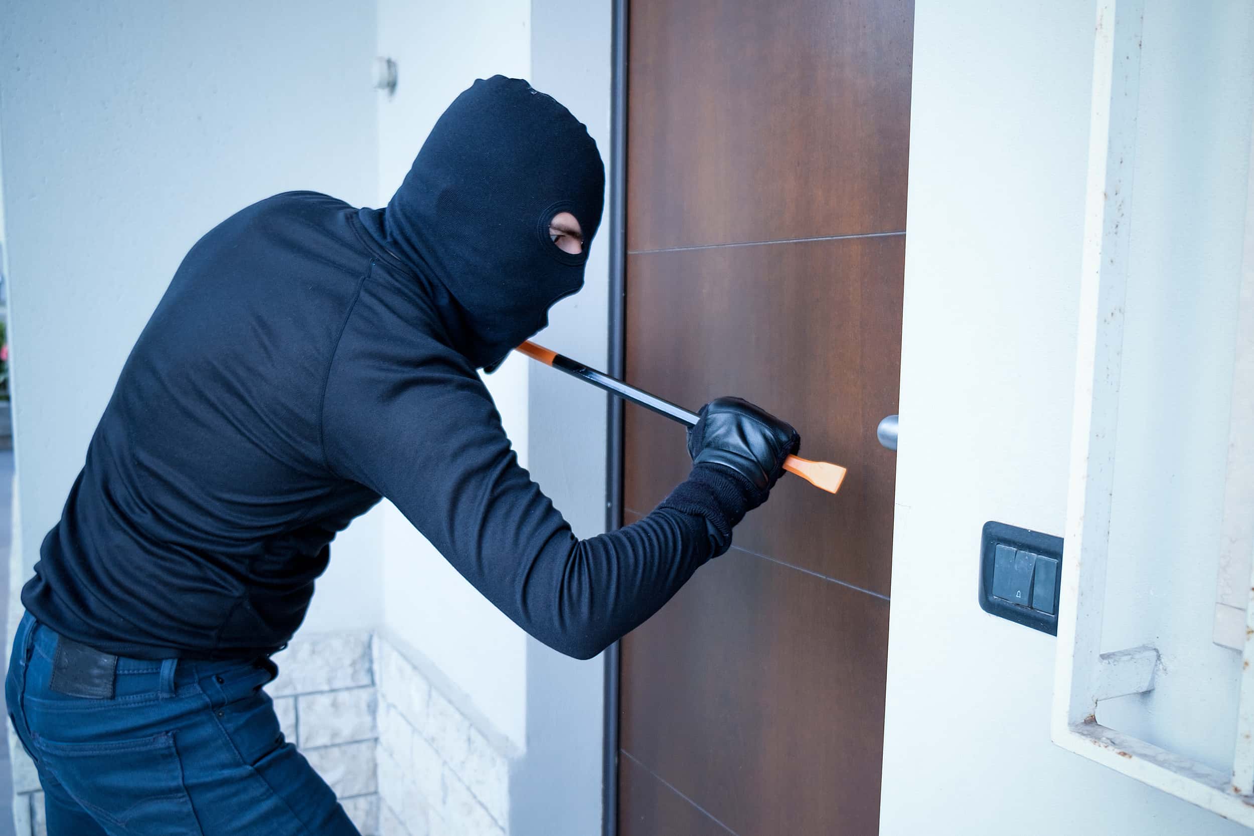 Burglar committing a burglary with a crowbar