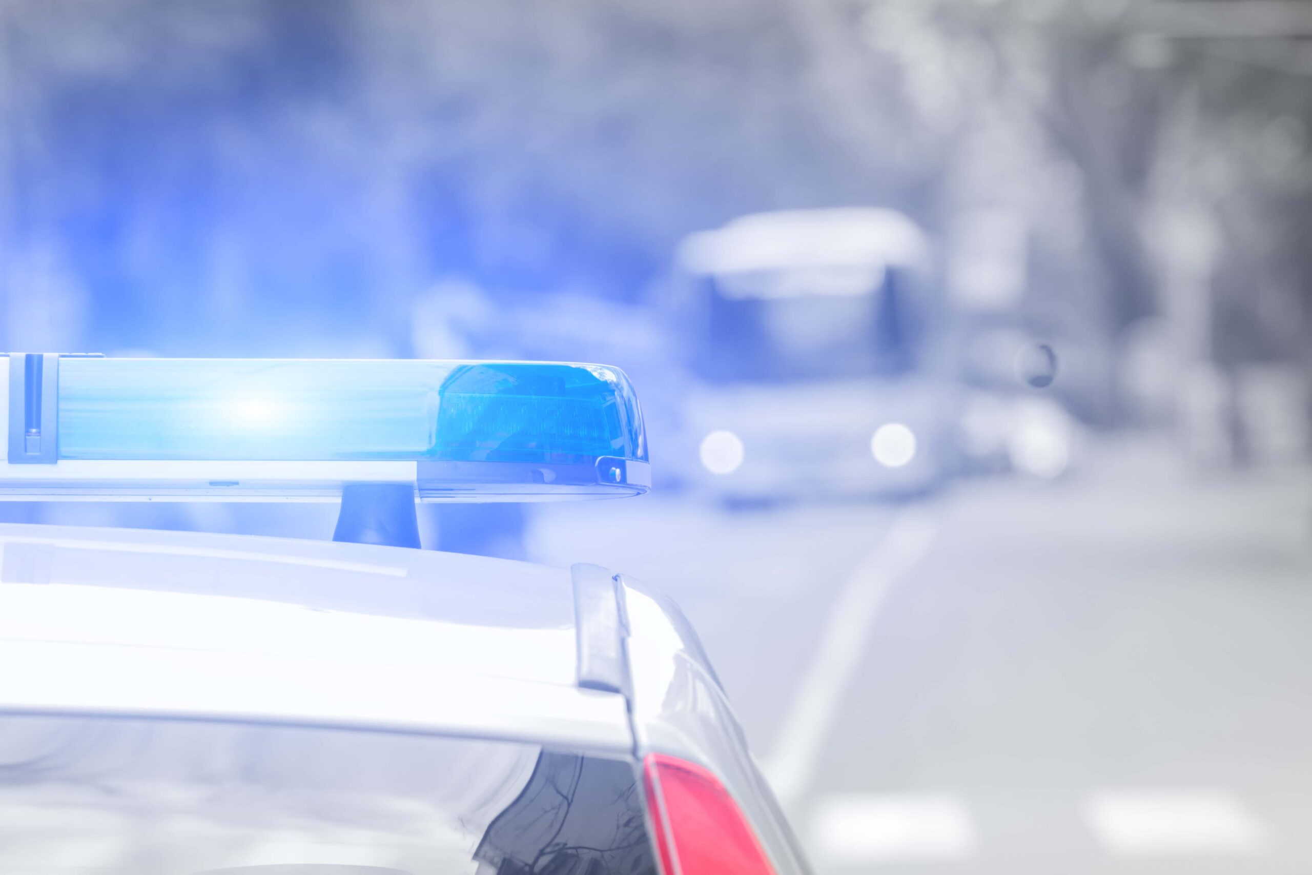Police car with flashing lights, representing a DUI arrest or traffic stop, requiring assistance from a DUI lawyer