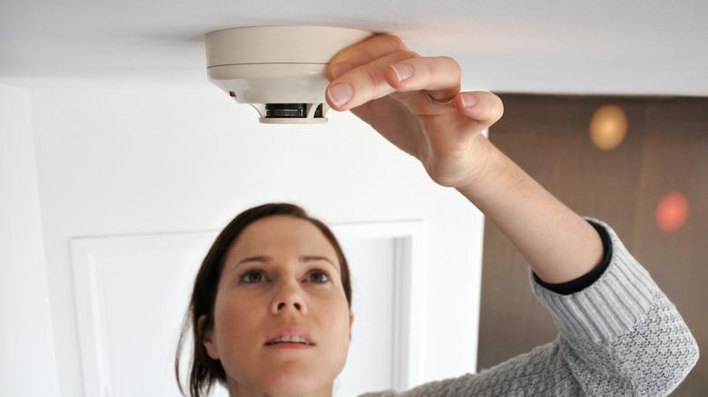 Person discovering a hidden camera in a hotel room related to unlawful surveillance cases in Nassau County